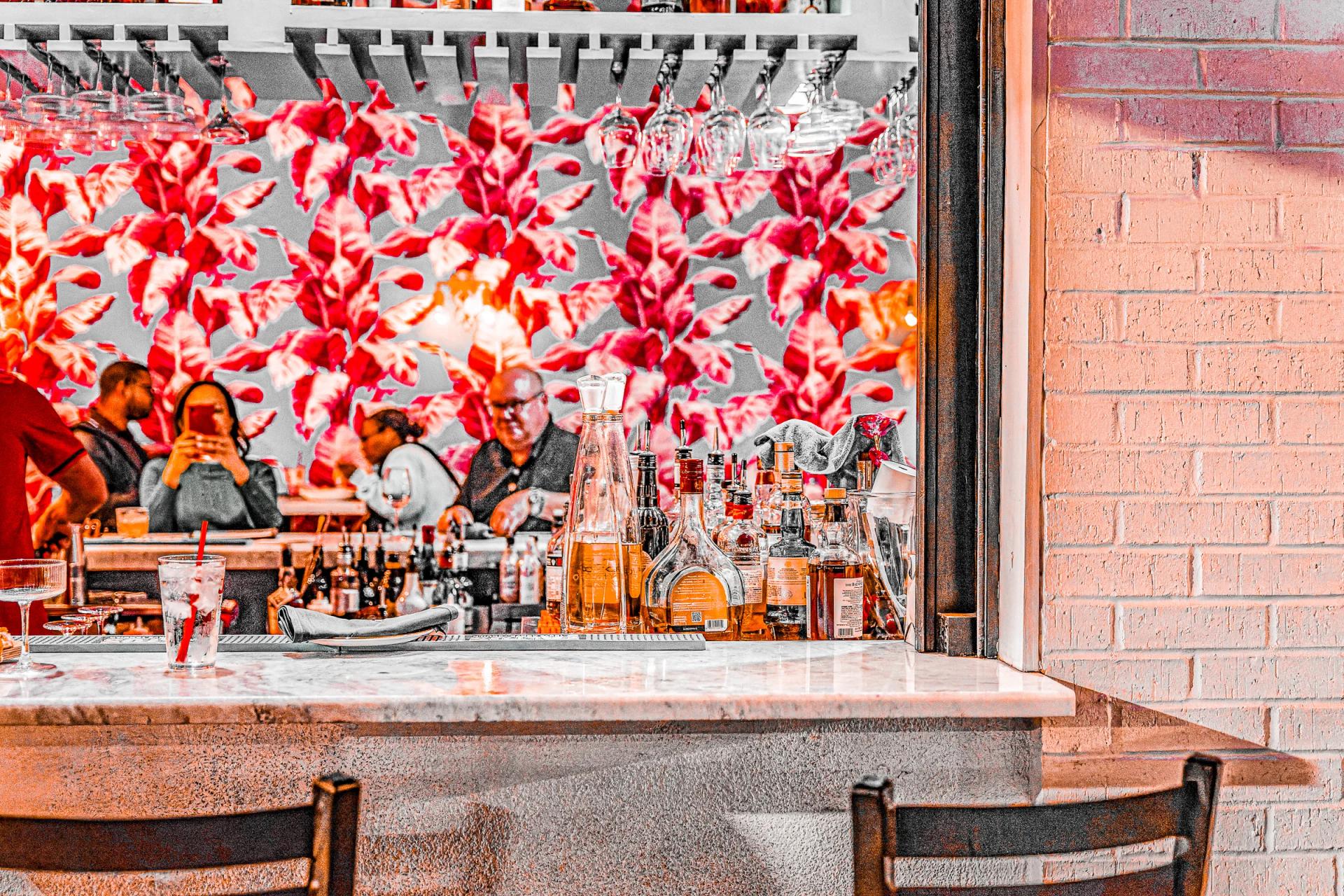 Bar interior with bottles and floral decor
