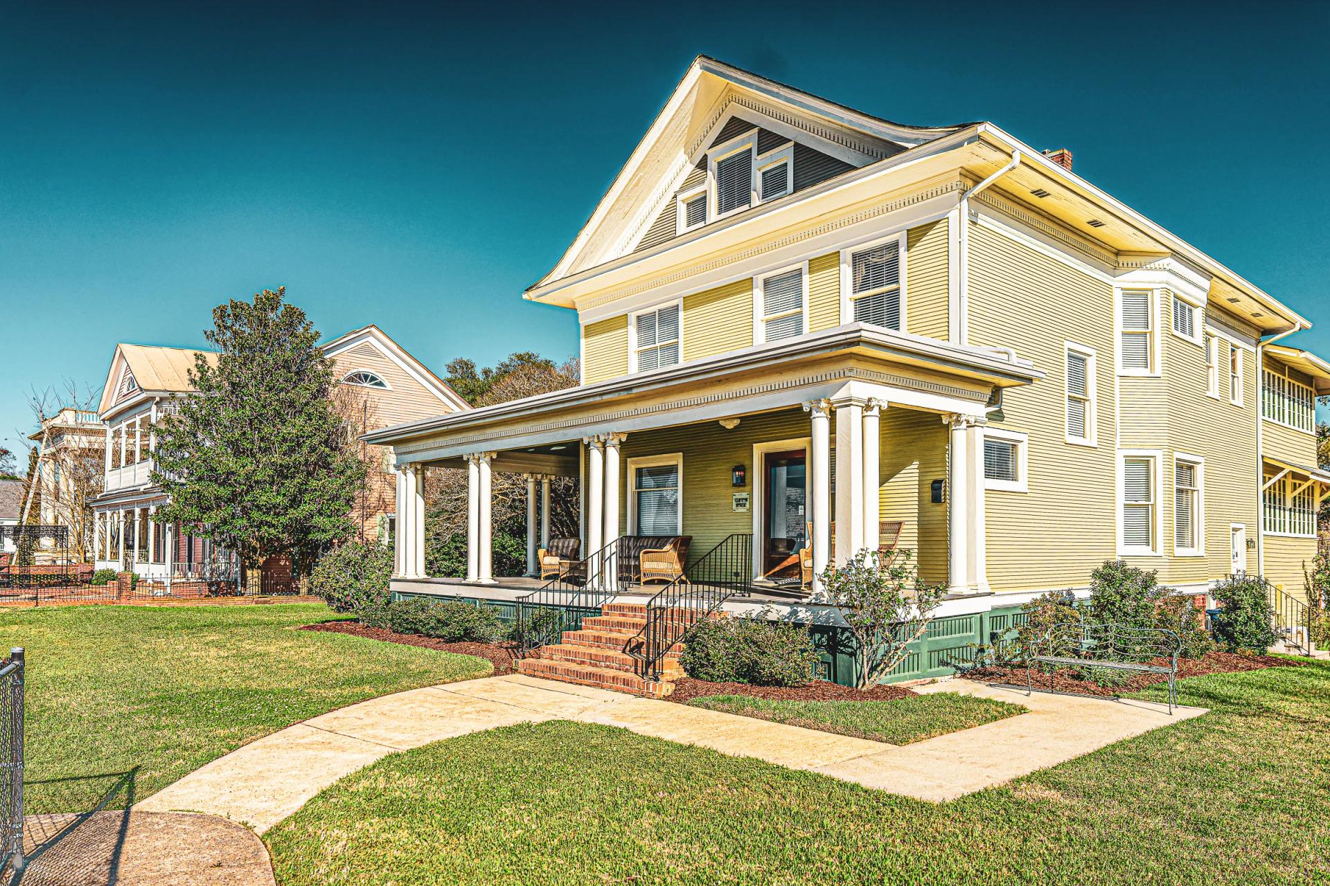 Antebellum mansion with iron fence and carriage